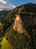 a huge swiss flag is fixed on a cliff photo