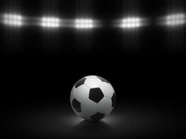 Soccer ball on a black background under stadium lights photo