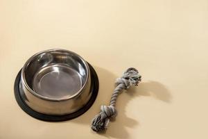 dog food bowl and toy on beige background with copy space, pets photo