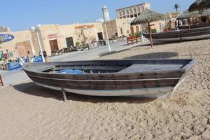 wooden boat on sandy beach photo