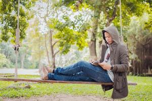 Asian man sitting and writing for a tree photo