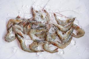 Raw shrimps prawns on ice in white plate, Fresh shrimp seafood , white shrimp top view photo