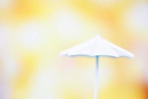 Close up white umbrella on bokeh and yellow blur background photo