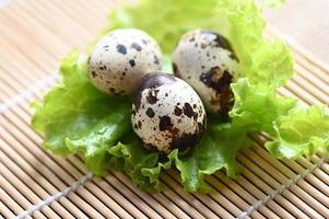 quail eggs on lettuce salad vegetable, fresh quail eggs on wooden table for cooking food photo