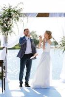 wedding ceremony on a high pier near the river photo