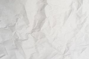 Wrinkled or crumpled white stencil paper or tissue used for background texture photo