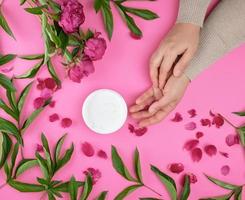 Women's hands and a jar of cream photo