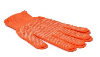 Orange textile work gloves on a white background. Protective clothing for manual workers, top view photo