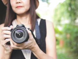 digital camera in Asian female tourist or photographer hand. photo