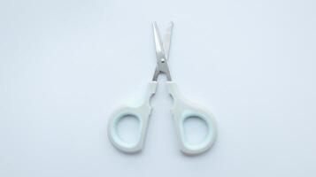 Small simple gray scissor isolated on white. photo