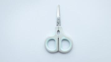 Small simple gray scissor isolated on white. photo