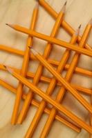 Yellow Pencil on Wooden Background photo