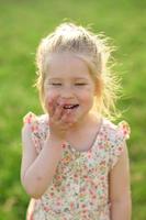 Little girl 3 years old in a summer sundress in the park. Summer time. photo