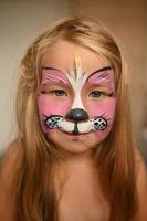 Little girl 3 years old with a painted face. photo