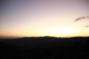 blur sunrise sunset sky view with fog on the top of mountain background photo