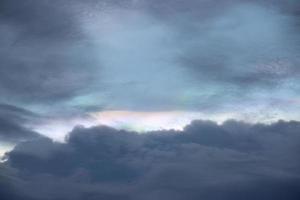 dark blue cloud with white light sky and sun ray with rainbow color reflection background photo