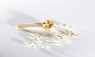 Spoons with vitamins, Vitamin D, omega 3, omega 6, Food supplement oil filled fish oil, vitamin A, vitamin E, flaxseed oil photo