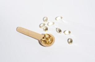 Spoons with vitamins, Vitamin D, omega 3, omega 6, Food supplement oil filled fish oil, vitamin A, vitamin E, flaxseed oil photo