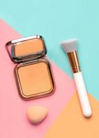 Makeup buffer brush with face powder and beauty makeup sponge. Beauty and makeup concept photo