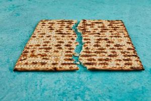 Pesach celebration concept - Jewish holiday Pesach. Matzah square broken in half photo