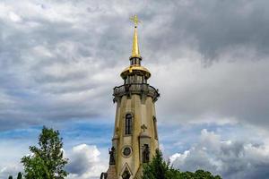Christian church cross in high steeple tower for prayer