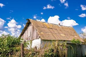 Beautiful old abandoned building farm house in countryside on natural background photo