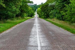 Beautiful empty asphalt road in countryside on colored background photo