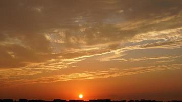 The beautiful sunset sky view with the colorful clouds and warm lights in the sky photo