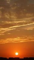 The beautiful sunset sky view with the colorful clouds and warm lights in the sky photo