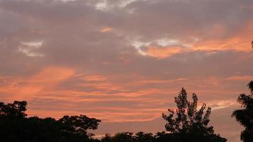 The beautiful sunset sky view with the colorful clouds and warm lights in the sky photo