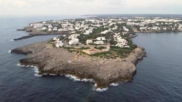 slow motion aerial view of the fort at the mouth of Cala Llonga, built in 1730 during the Spanish War of Succession photo