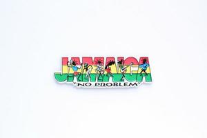 Colourful PVC souvenir fridge magnet of Jamaica on white background. Travel memory concept. Gift typical product for tourists from foreign trip. Home decoration. Top view, flat lay, close up photo