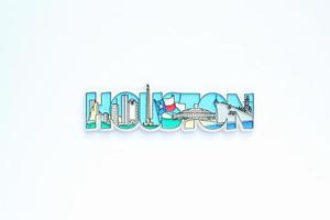 Colourful PVC souvenir fridge magnet of Houston, USA on white background. Travel memory concept. Gift typical product for tourists from foreign trip. Home decoration. Top view, flat lay, close up photo