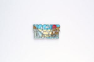 Colourful PVC souvenir fridge magnet of Hoover Dam, USA on white background. Travel memory concept. Gift typical product for tourists from foreign trip. Home decoration. Top view, flat lay, close up photo