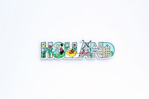 Colourful PVC souvenir fridge magnet of Holland on white background. Travel memory concept. Gift typical product for tourists from foreign trip. Home decoration. Top view, flat lay, close up photo