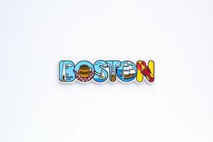 Colourful PVC souvenir fridge magnet of Boston, USA on white background. Travel memory concept. Gift typical product for tourists from foreign trip. Home decoration. Top view, flat lay, close up photo