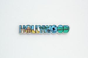 Colourful PVC souvenir fridge magnet of Hollywood, USA on white background. Travel memory concept. Gift typical product for tourists from foreign trip. Home decoration. Top view, flat lay, close up photo