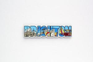 Colourful PVC souvenir fridge magnet of Brighton, England on white background. Travel memory concept. Gift typical product for tourists from foreign trip. Home decoration. Top view, flat lay, close up photo
