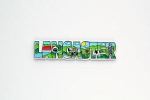 Colourful PVC souvenir fridge magnet of Lancaster, USA on white background. Travel memory concept. Gift typical product for tourists from foreign trip. Home decoration. Top view, flat lay, close up photo