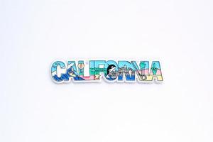 Colourful PVC souvenir fridge magnet of California, USA on white background. Travel memory concept. Gift typical product for tourists from foreign trip. Home decoration. Top view, flat lay, close up photo
