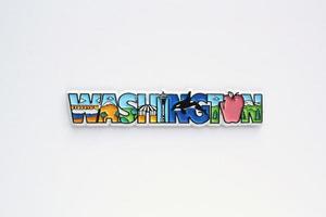 Colourful PVC souvenir fridge magnet of Washington, USA on white background. Travel memory concept. Gift typical product for tourists from foreign trip. Home decoration. Top view, flat lay, close up photo