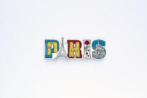 Colourful PVC souvenir fridge magnet of Paris, France on white background. Travel memory concept. Gift typical product for tourists from foreign trip. Home decoration. Top view, flat lay, close up photo