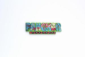 Colourful PVC souvenir fridge magnet of Pangkor, Malaysia on white background. Travel memory concept. Gift typical product for tourists from foreign trip. Home decoration. Top view, flat lay, close up photo