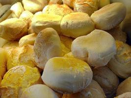 Close up stack of fresh baked short round bread, yellow warm tone, ready to sell in Bakery pastry shop photo