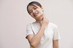 Asian woman having an itchy neck photo