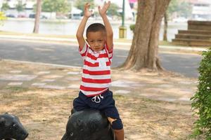 boy playing in the playground in the park photo