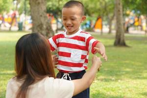 The boy ran to hug his mother. photo