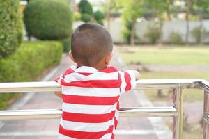 The boy stood on the corridor leading up to the building. photo