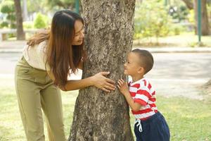 Mother and baby playing in the park happily. photo