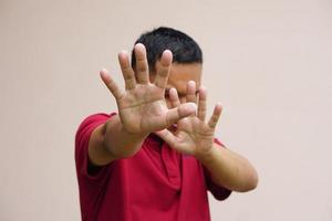 man raised her hand for dissuade, campaign stop violence against man. photo